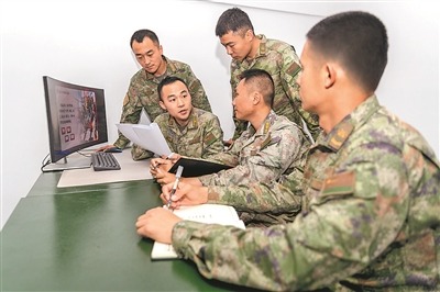 “教育團隊”成員正在研究制作課件內容。曾冰陽攝